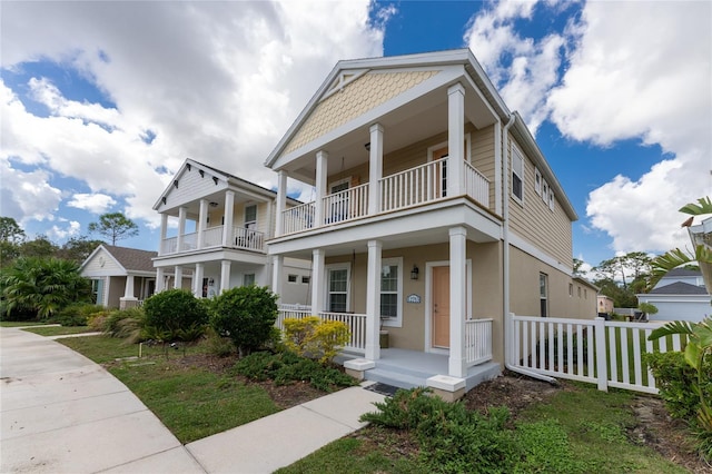 12753 Sagewood Dr, Venice, FL 34293 - neoclassical home with a balcony, covered porch, and stucco siding