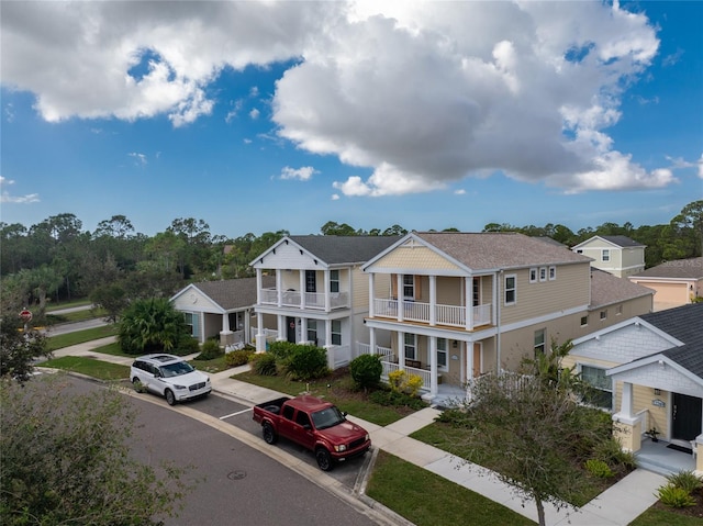12753 Sagewood Dr, Venice, FL 34293 - view of front of home featuring a balcony, a porch, a shingled roof, and a residential view