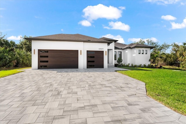 view of front of house featuring a garage and a front lawn