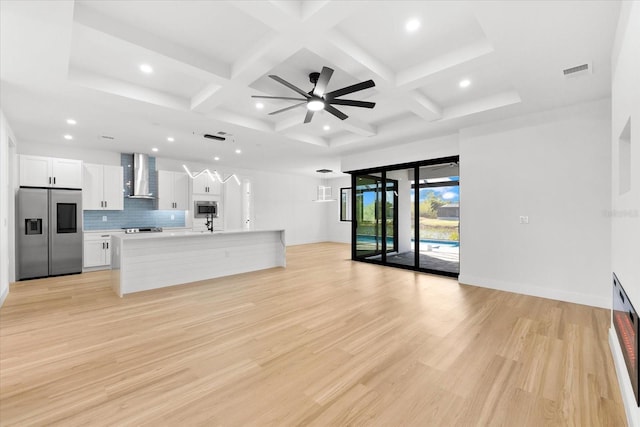 unfurnished living room with ceiling fan, light hardwood / wood-style floors, and coffered ceiling