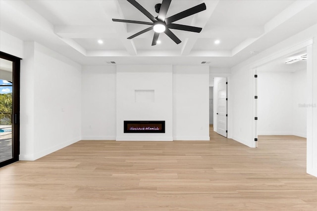 unfurnished living room featuring ceiling fan and light hardwood / wood-style floors