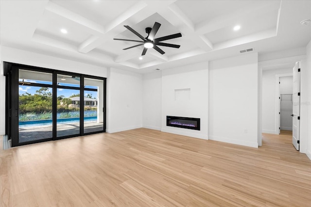 unfurnished living room featuring beamed ceiling, ceiling fan, light hardwood / wood-style floors, and coffered ceiling