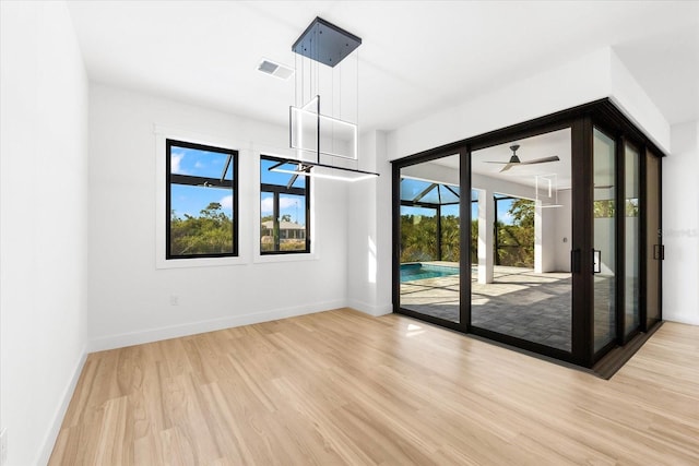 spare room featuring ceiling fan and light hardwood / wood-style floors