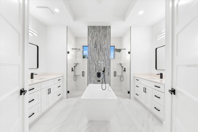 bathroom with vanity and shower with separate bathtub