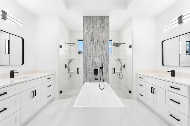 bathroom with vanity and shower with separate bathtub