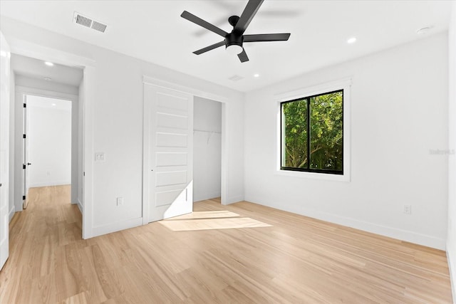 unfurnished bedroom with a closet, light hardwood / wood-style floors, and ceiling fan