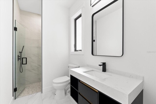 bathroom with vanity, toilet, and walk in shower