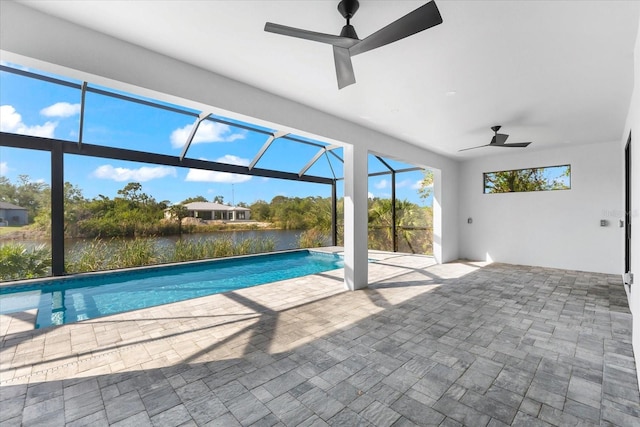 view of pool featuring a lanai, ceiling fan, a patio area, and a water view