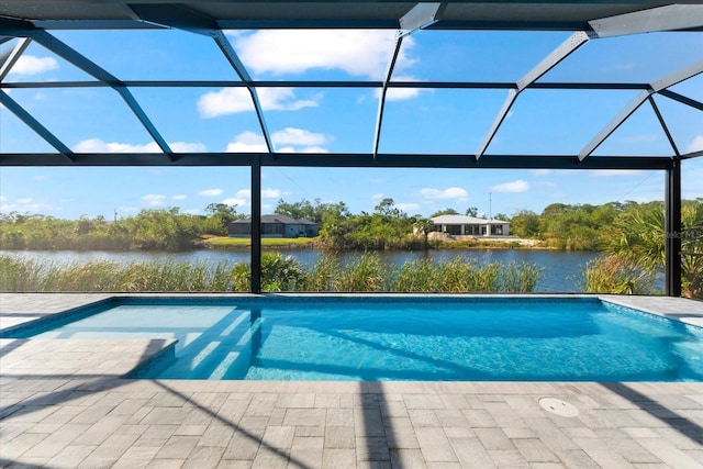 view of pool with a lanai, a water view, and a patio