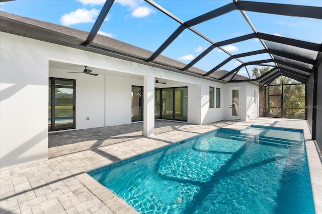 view of pool with ceiling fan, a patio, and glass enclosure