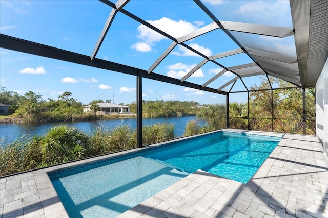 view of swimming pool featuring a water view, glass enclosure, and a patio area