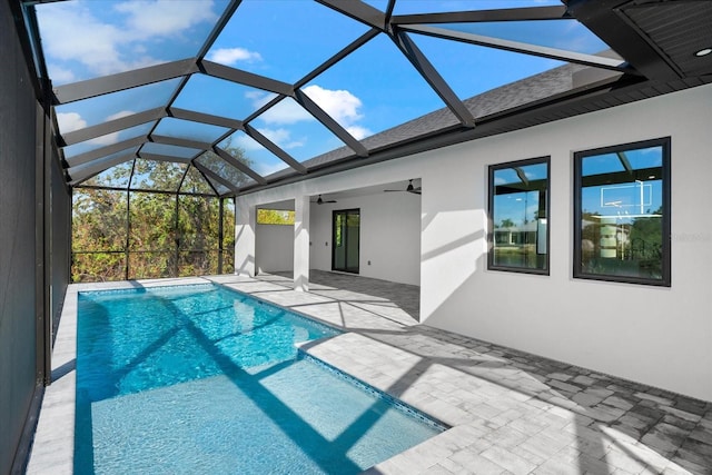 view of pool with ceiling fan, a patio, and glass enclosure