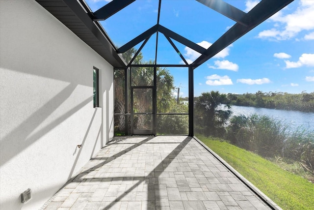 unfurnished sunroom with a water view and vaulted ceiling