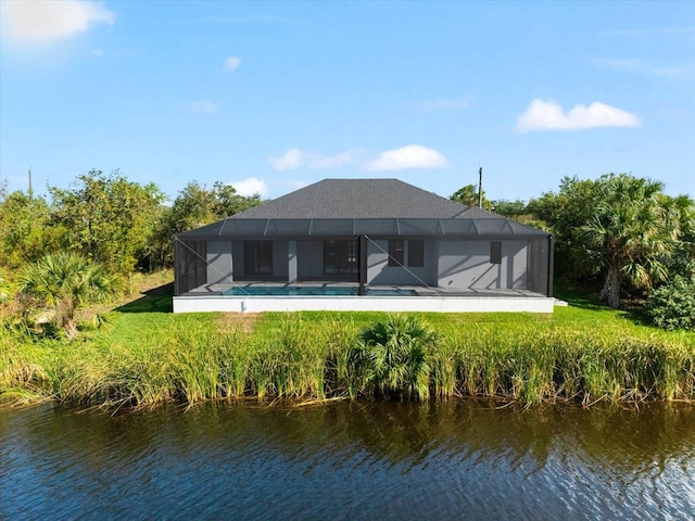 rear view of property featuring a yard, a water view, and a lanai