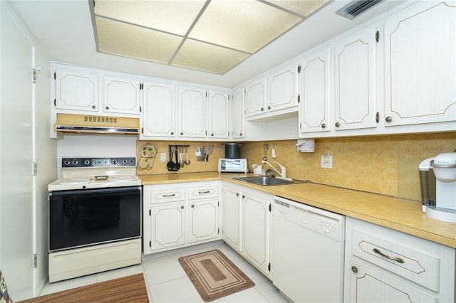 kitchen featuring backsplash, white cabinetry, light tile patterned floors, sink, and white appliances