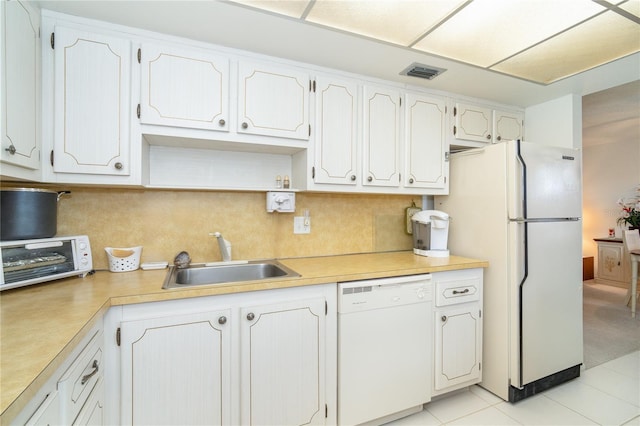 kitchen with white cabinetry, tasteful backsplash, sink, and white appliances