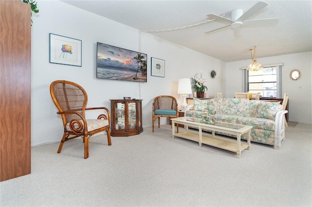 carpeted living room with ceiling fan