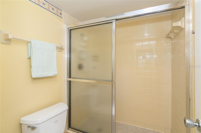 bathroom with walk in shower and toilet