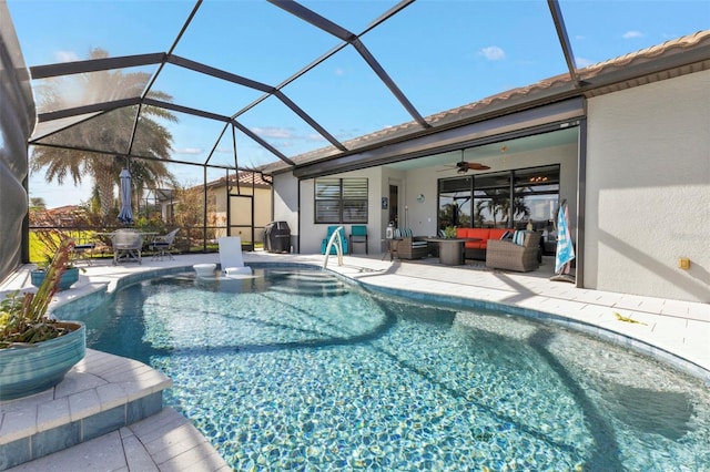 view of swimming pool with an outdoor living space, a patio area, ceiling fan, and glass enclosure