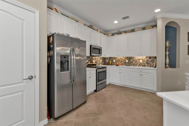 kitchen featuring tasteful backsplash, crown molding, appliances with stainless steel finishes, and white cabinets