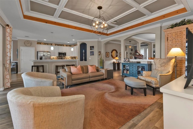 living room with crown molding, coffered ceiling, a chandelier, and hardwood / wood-style flooring