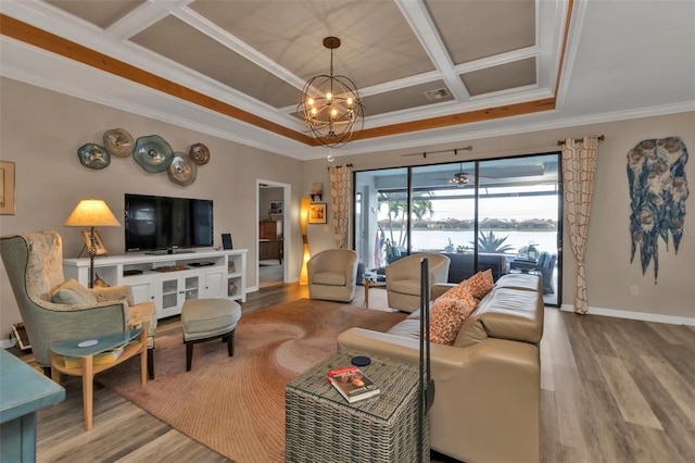 living room featuring ornamental molding, a chandelier, and wood-type flooring