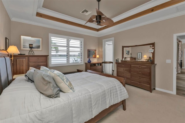 carpeted bedroom featuring ornamental molding, a raised ceiling, and ceiling fan