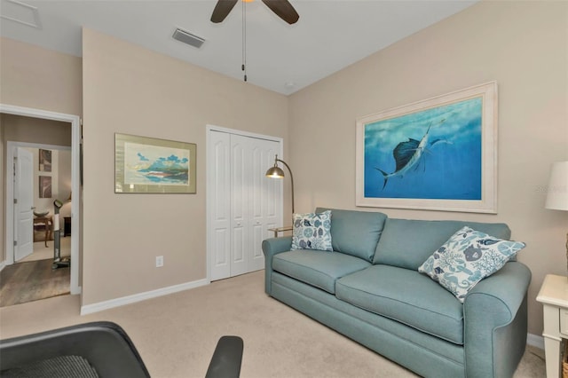 living room with light colored carpet and ceiling fan