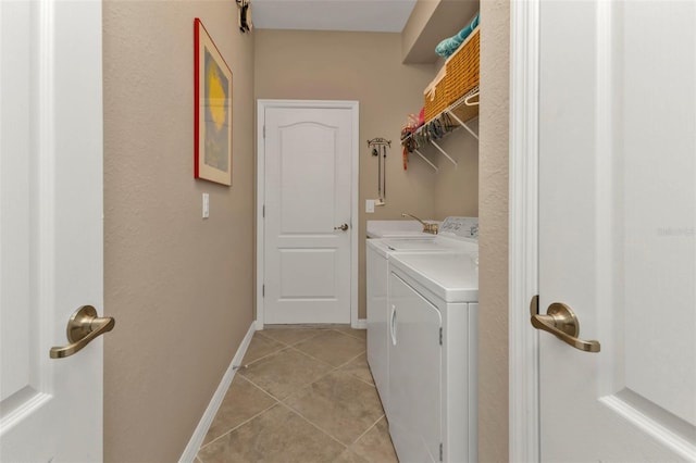 washroom featuring light tile patterned flooring, sink, and washer and dryer