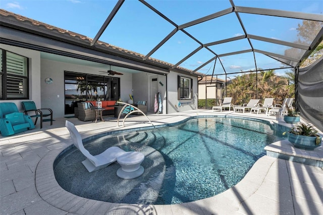 view of swimming pool featuring an outdoor living space, a patio, a lanai, and ceiling fan