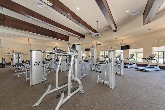 gym featuring a towering ceiling and ceiling fan