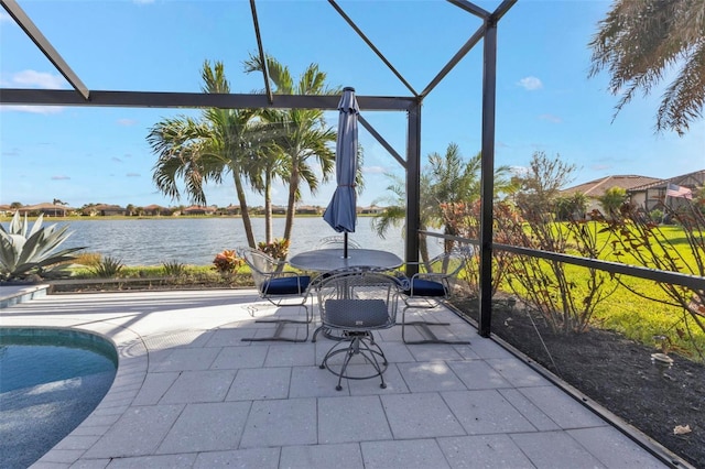 sunroom / solarium featuring a water view