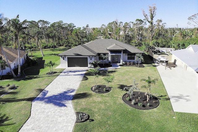 view of front of house with a front yard and a garage