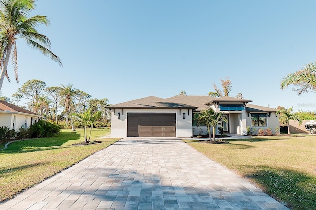 view of front of property with a garage and a front lawn