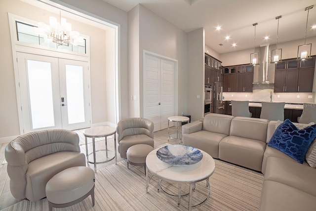 living room with french doors, a chandelier, and sink