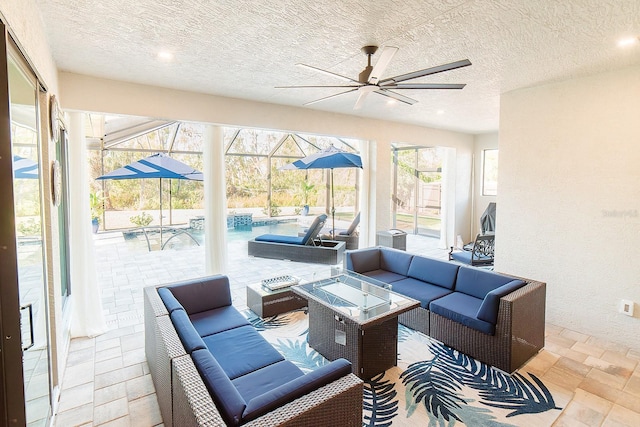 sunroom featuring ceiling fan