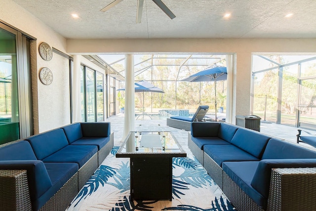 sunroom / solarium featuring ceiling fan