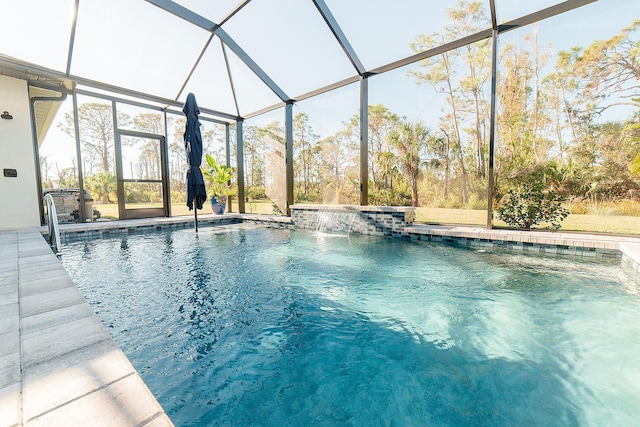 view of pool with pool water feature and glass enclosure