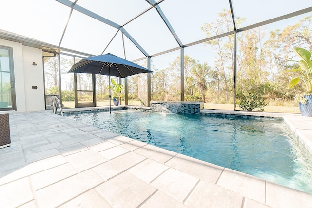 view of swimming pool featuring pool water feature, glass enclosure, and a patio area