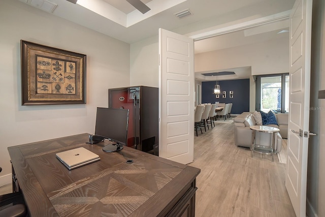 office featuring an inviting chandelier and light wood-type flooring