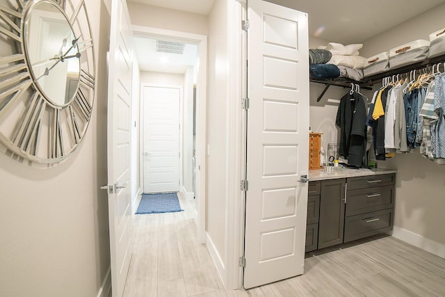 walk in closet featuring light hardwood / wood-style flooring