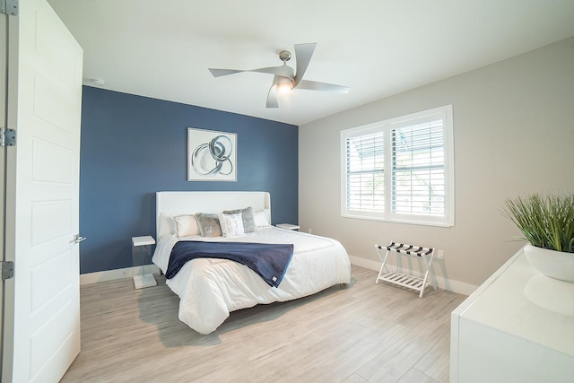 bedroom featuring light wood-type flooring and ceiling fan