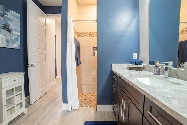 bathroom with a shower with curtain, vanity, and hardwood / wood-style flooring