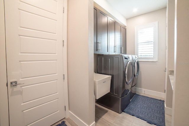 laundry area featuring cabinets and independent washer and dryer