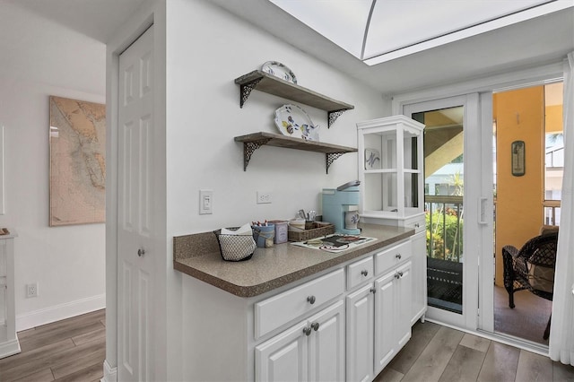 kitchen featuring white cabinets and dark hardwood / wood-style floors