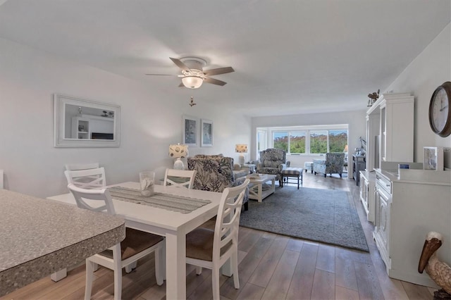 dining area featuring hardwood / wood-style floors and ceiling fan