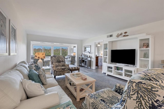 living room with dark hardwood / wood-style floors and ceiling fan