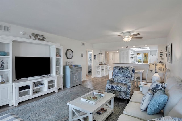 living room featuring dark hardwood / wood-style floors and ceiling fan