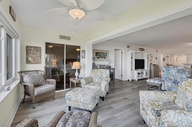 living room featuring ceiling fan and hardwood / wood-style floors