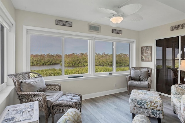 sunroom featuring ceiling fan